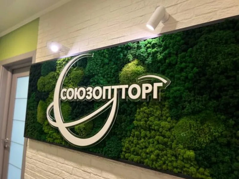 Готовый логотип «Союзоптторг» из мха на стене